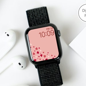 May include: A black smartwatch with a black band and a pink watch face with a pattern of red hearts. The watch face displays the time as 10:09 and the date as FRI 23.