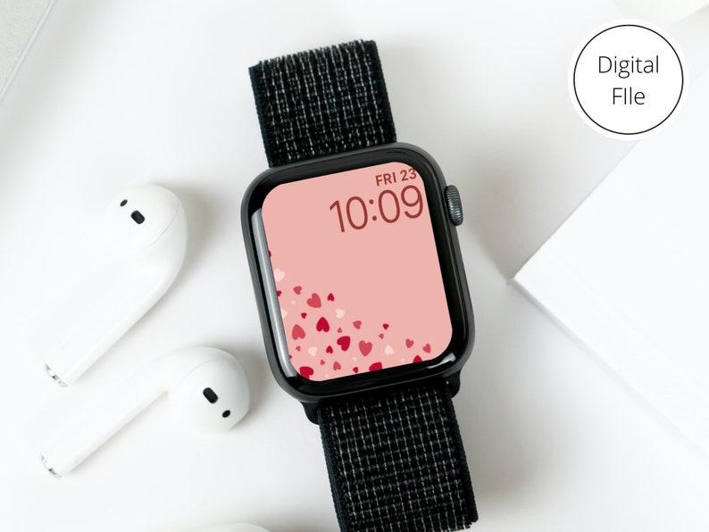 May include: A black smartwatch with a black band and a pink watch face with a pattern of red hearts. The watch face displays the time as 10:09 and the date as FRI 23.