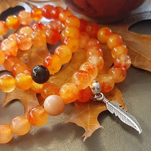 Truth, orange bracelet, red yellow jasper, orange jade, feather charm, obsidian, sunstone, indiginous support, gemstones for mental health