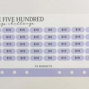 May include: A white and lavender savings challenge tracker with the text "SAVE FIVE HUNDRED savings challenge." The tracker has a grid of boxes with dollar amounts from $6 to $20. The bottom has holes for a binder.
