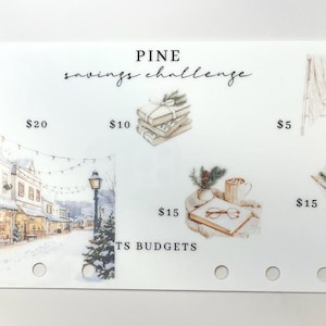 May include: A white savings challenge card with watercolor illustrations and the text "PINE savings challenge." The card features images of a snowy town, books, a Christmas tree, and a bouquet of pine. Amounts of $20, $10, $5, and $15 are indicated.