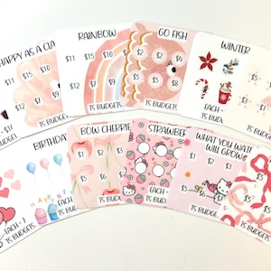May include: A collection of illustrated budget cards with themes like summer, rainbow, and hearts. Each card features a unique design with price points and the text "TS Budgets". The cards are in various shades of pink and white.