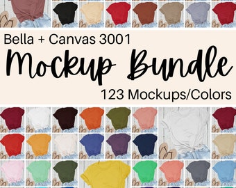 Könnte beinhalten: Eine Sammlung von 123 Bella + Canvas 3001 T-Shirt-Mockups in verschiedenen Farben. Die Shirts liegen flach auf einer Holzoberfläche mit einem Paar Flip-Flops neben jedem Shirt.