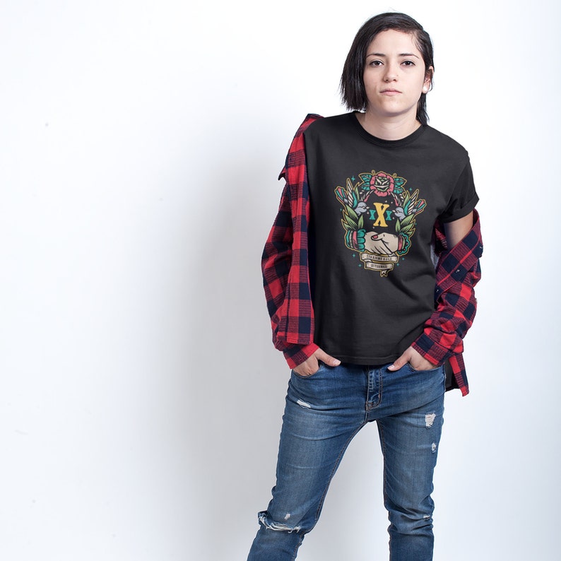 May include: Black t-shirt with a colorful graphic of two hands shaking with a floral design and the text "The Embrace of Freedom".