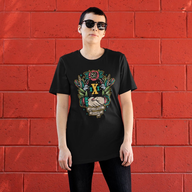 May include: Black t-shirt with a colorful graphic design featuring a handshake, two birds, a rose, and the text "Stay Right Good Together".