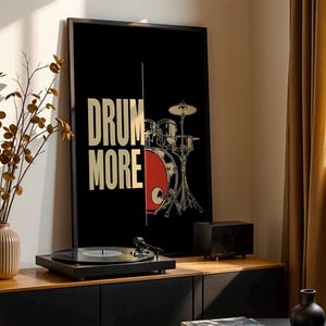 May include: Black and gold poster with a drum set and the text "Drum More".