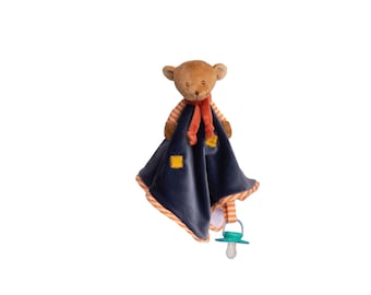 May include: A brown teddy bear plush toy with a navy blue blanket. The blanket has orange trim and two yellow square patches. The bear has an orange scarf and striped arms. A teal pacifier is attached to the blanket.