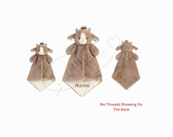 May include: A brown plush cow security blanket with a white face and a white belly. The blanket is folded in half and the cow's head is sticking out. The blanket is personalized with the name "Name".
