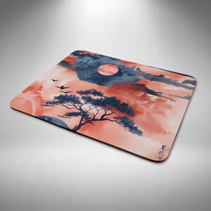 May include: Rectangular mouse mat with a watercolour landscape depicting a tree, birds, and a setting sun. The colour scheme includes coral, navy blue, and white. The design has a Japanese aesthetic.