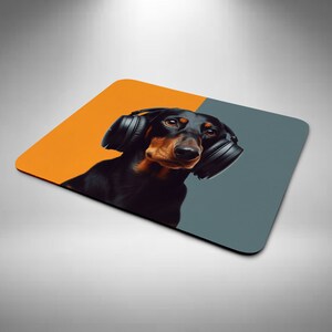 May include: A black and brown dachshund wearing black headphones against a yellow and grey background.
