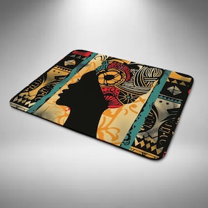 May include: Rectangular mouse mat with a black silhouette of a person's profile and a patterned head covering. The design includes red, yellow, blue, and black geometric and floral patterns. The background is beige.