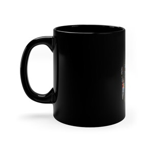 May include: A black ceramic coffee mug with a colorful design on the side.