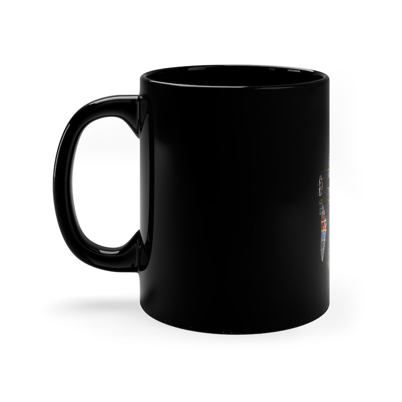 May include: A black ceramic coffee mug with a colorful design on the side.