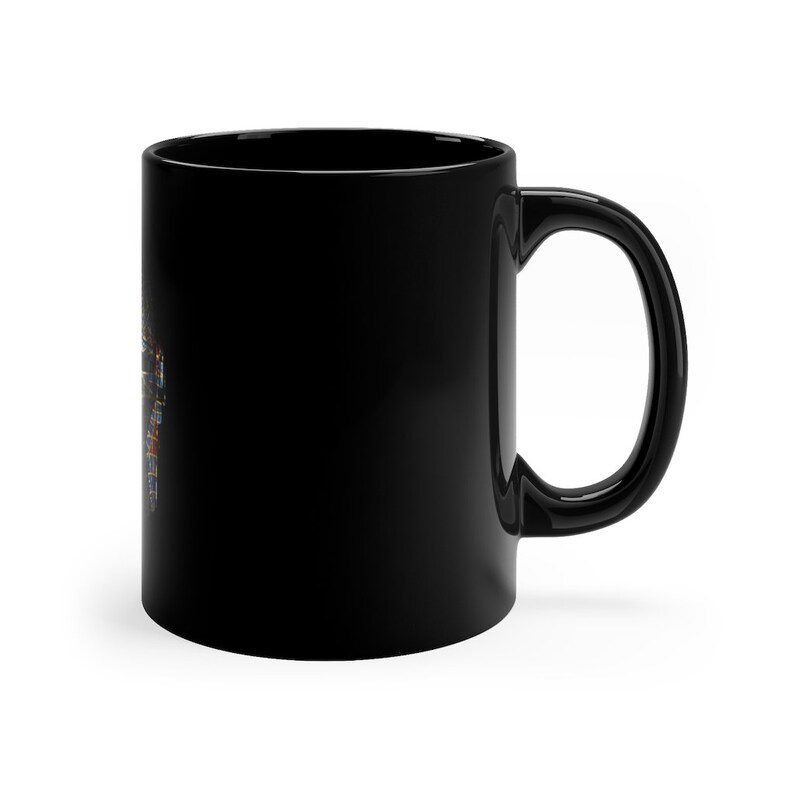 May include: A black ceramic coffee mug with a handle. The mug is blank.