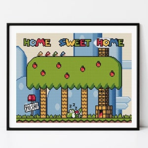 Könnte beinhalten: Gerahmtes Kreuzstich-Kunstwerk mit schwarzem Rahmen, das eine pixelige Szene mit dem Text "HOME SWEET HOME" zeigt. Das Bild zeigt einen grünen Baum mit roten Äpfeln, Vögeln und einem schlafenden Yoshi im Retro-Videospiel-Stil.
