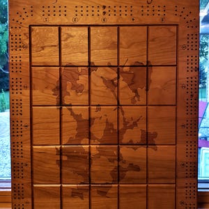 May include: A wooden game board with a map of Jackfish Lake, engraved with the text "Jackfish Lake" and "Drop a line and raise a glass".