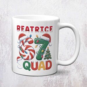 May include: White ceramic mug featuring the text "BEATRICE 67 SQUAD" in red, green, and yellow. The "67" is designed with a candy cane and a green number seven, both adorned with Santa hats and Christmas lights. A small Christmas tree is also included.