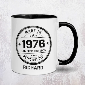 May include: White ceramic mug with a black interior and handle. The mug features a black and white circular design with the text "MADE IN 1976 LIMITED EDITION RETRO NOT OLD RICHARD". The mug is a standard size.