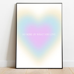 May include: A framed print featuring a gradient heart shape in shades of blue, pink, and yellow. The text "DO MORE OF WHAT YOU LOVE." is printed in white on the print.