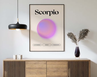 May include: A framed art print featuring the word "Scorpio" in black above a gradient purple and pink sphere. Below the sphere are the words "Determined", "Brave", and "Passionate". The print is displayed on a light beige background.