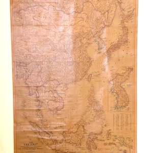 May include: A vintage map of the Far East, printed on a beige background with brown lines and text. The map shows the countries of China, Japan, Korea, Indochina, and the Philippines. The map is titled "The Far East" and is from the National Geographic Magazine.