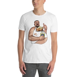 May include: White t-shirt featuring a cartoon illustration of a person holding a chicken leg and a bottle of mayonnaise. The person is wearing a white vest and has a large belly. The text on the bottle reads "MAYO".