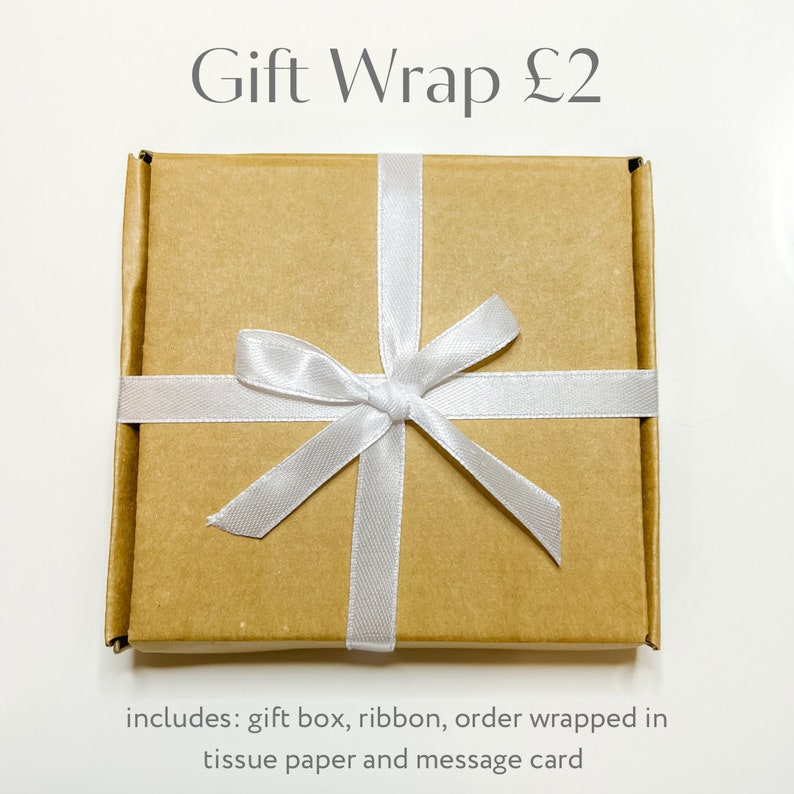 May include: A brown gift box with a white ribbon tied in a bow. The box is wrapped in tissue paper and includes a message card. Gift Wrap &pound;2.