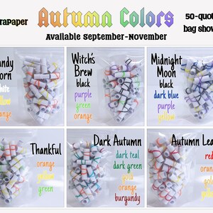 May include: A collection of six clear plastic bags filled with small, rolled paper scrolls secured by colored rubber bands. Each bag is labeled with a theme name and a list of the specific rubber band colors included, such as Candy Corn, Witch's Brew, Midnight Moon, Thankful, Dark Autumn, and Autumn Leaves.
