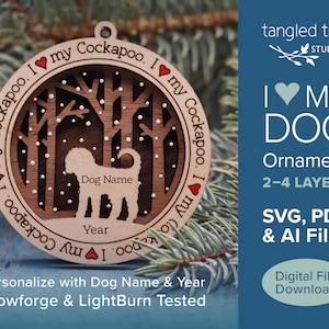 May include: A wooden, layered dog ornament with the text "I my Cockapoo" around the edge. The ornament features a dog silhouette, space for a name and year, and a winter forest scene. The text "I ❤️ MY DOG" is also visible.
