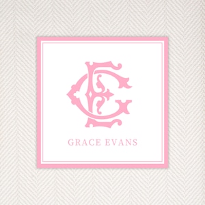 May include: A pink and white monogrammed card with the initials "GE" in a decorative font. The text "GRACE EVANS" is printed below the monogram.