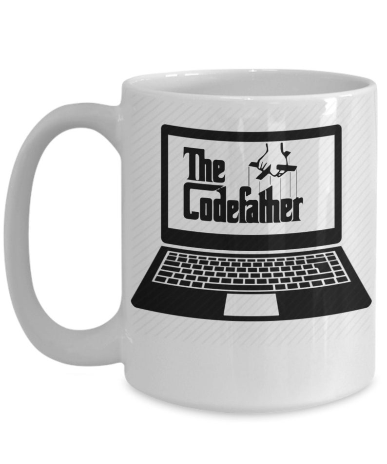 May include: White ceramic coffee mug featuring a black and white image of a laptop with the text "The CodeFather" displayed on the screen. The laptop is set against a white background with a subtle striped pattern.