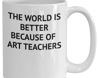 May include: White ceramic coffee mug with black text that reads "The world is better because of art teachers."