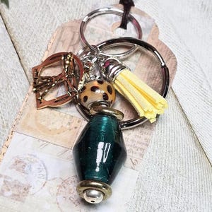 Green Glass Beaded Keychains with Vitruvian Man charm and tassel, Qty: 1