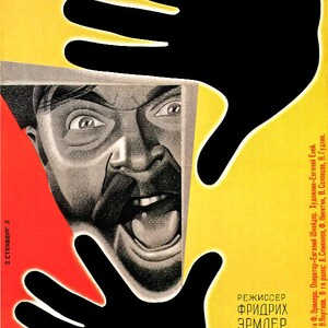 May include: A vintage movie poster with a black and white image of a man's face with a wide open mouth. The poster is in red, yellow, and black with the text "OBLOMoK" and "IMPERII" in large, bold letters. The poster also includes the text "2 CTENBEPT 2" and "РЕЖИССЕР ФРИДРИХ ЭРМЛЕР" in smaller letters.