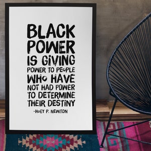 May include: Black and white framed print with the quote "Black Power is giving power to people who have not had power to determine their destiny - Huey P. Newton".