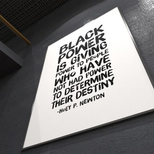 May include: Black and white typography poster with the quote "Black Power is giving power to people who have not had power to determine their destiny." - Huey P. Newton.