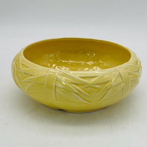 May include: A handcrafted wooden sign, painted white with a distressed finish, displaying the text "Welcome to our home" in a handwritten font. It has a black border and a small heart decoration.