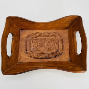 May include: A wooden serving tray with carved handles and a carved design that reads "Give Us This Day Our Daily Bread".
