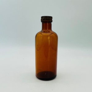 Old Amber Brown Bottle with a Rusty Twist Cap