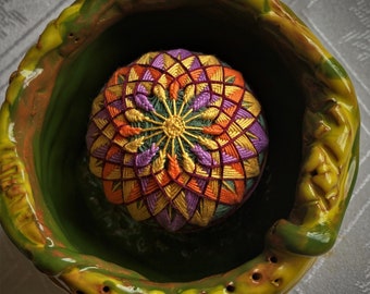 Temari ball  in a ceramic bowl.