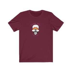 May include: A maroon t-shirt with a skull graphic. The skull has a rainbow over its eyes and the text "Thank You" above it. The text "algorithm" is written below the skull in a cursive font.