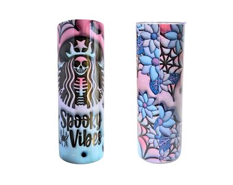 May include: A pair of tall, insulated tumblers. One features a skeleton design within a logo, with the words "Spooky Vibes." The other has a floral pattern with spiderwebs, in shades of pink, blue, and white.