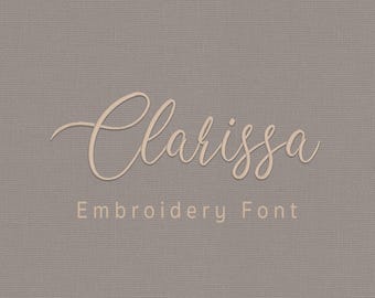 May include: A digital graphic featuring the name Clarissa in a light beige cursive script font centered on a solid taupe background. Below the name, the text Embroidery Font is displayed in a simple sans-serif font, with AikaStitch at the bottom.