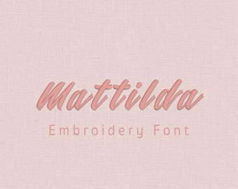 May include: A digital display featuring the name Mattilda in a stylized, dark pink cursive script. Below the name, the text Embroidery Font is written in a lighter pink, and at the bottom, the text Aika Stitch is centered on a light pink background.