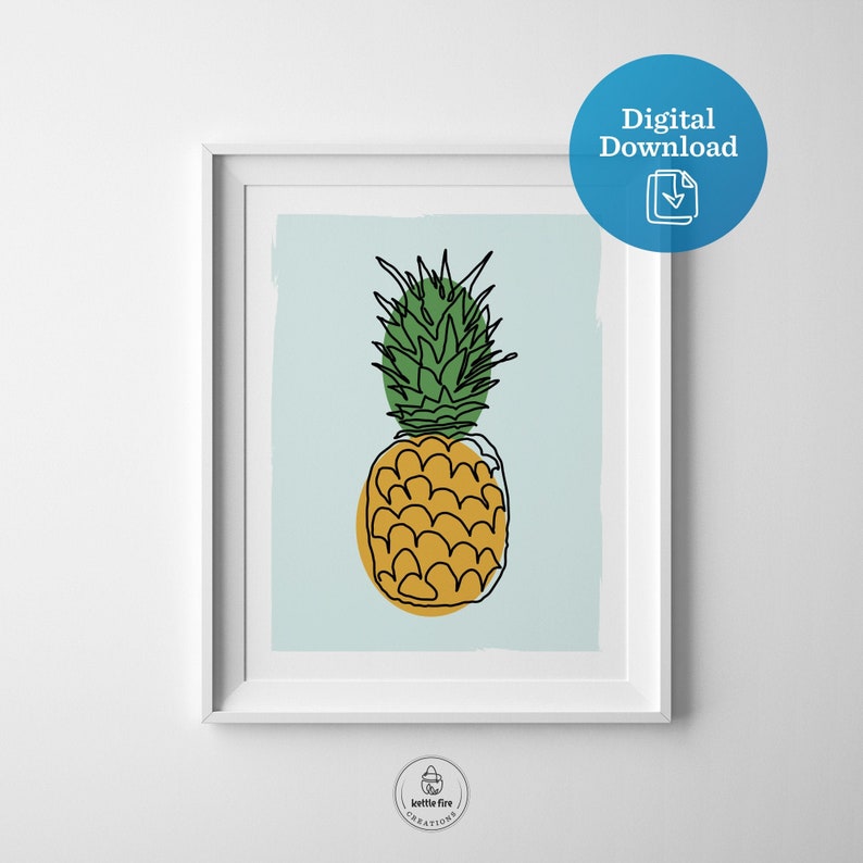 Kitchen wall art of pineapple with gold base and green leaves on blue background. Shown in frame.