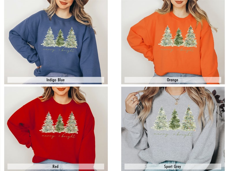 May include: A Christmas sweatshirt featuring a watercolour design of three pine trees and the text "merry & bright". The sweatshirt is available in four colours: indigo blue, orange, red, and sport grey.
