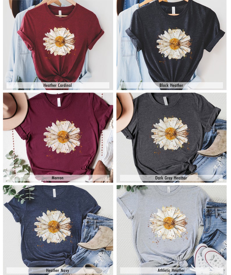 Pode incluir: Uma camiseta com uma estampa de margarida em aquarela em v&aacute;rias cores, incluindo marrom, vermelho-cardeal mesclado, preto mesclado, cinza escuro mesclado, azul marinho mesclado e cinza mesclado atl&eacute;tico.