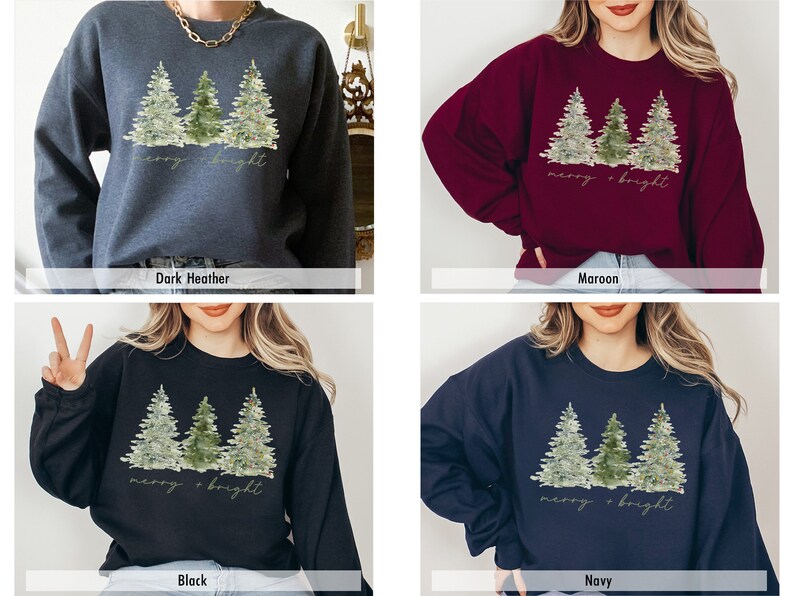 May include: A Christmas sweatshirt featuring a watercolour design of three pine trees with lights and the text "merry + bright". The sweatshirt is available in four colours: dark heather, maroon, black, and navy.