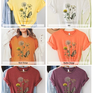 May include: A set of six t-shirts featuring a vintage botanical illustration of dandelions. The shirts are available in yellow, ash, burnt orange, heather orange, heather clay, and heather maroon.