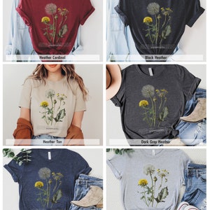 May include: A collection of t-shirts featuring a vintage botanical illustration of dandelions. The shirts are available in a variety of colors, including heather cardinal, black heather, heather tan, dark grey heather, heather navy, and athletic heather.